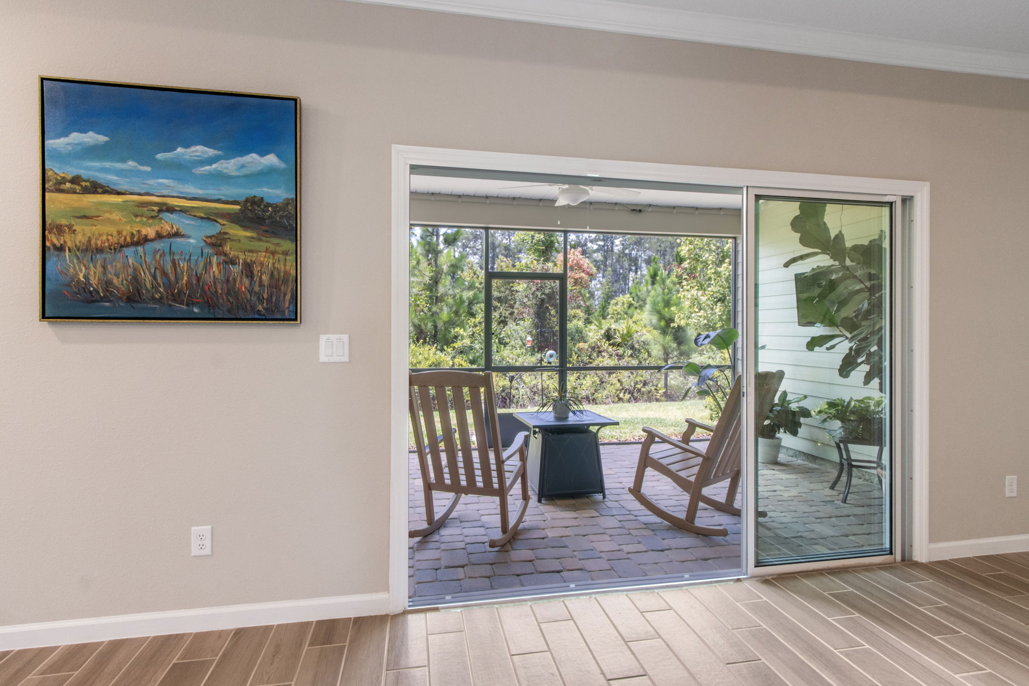 Access your relaxing covered and screened lanai through stackable glass sliders...