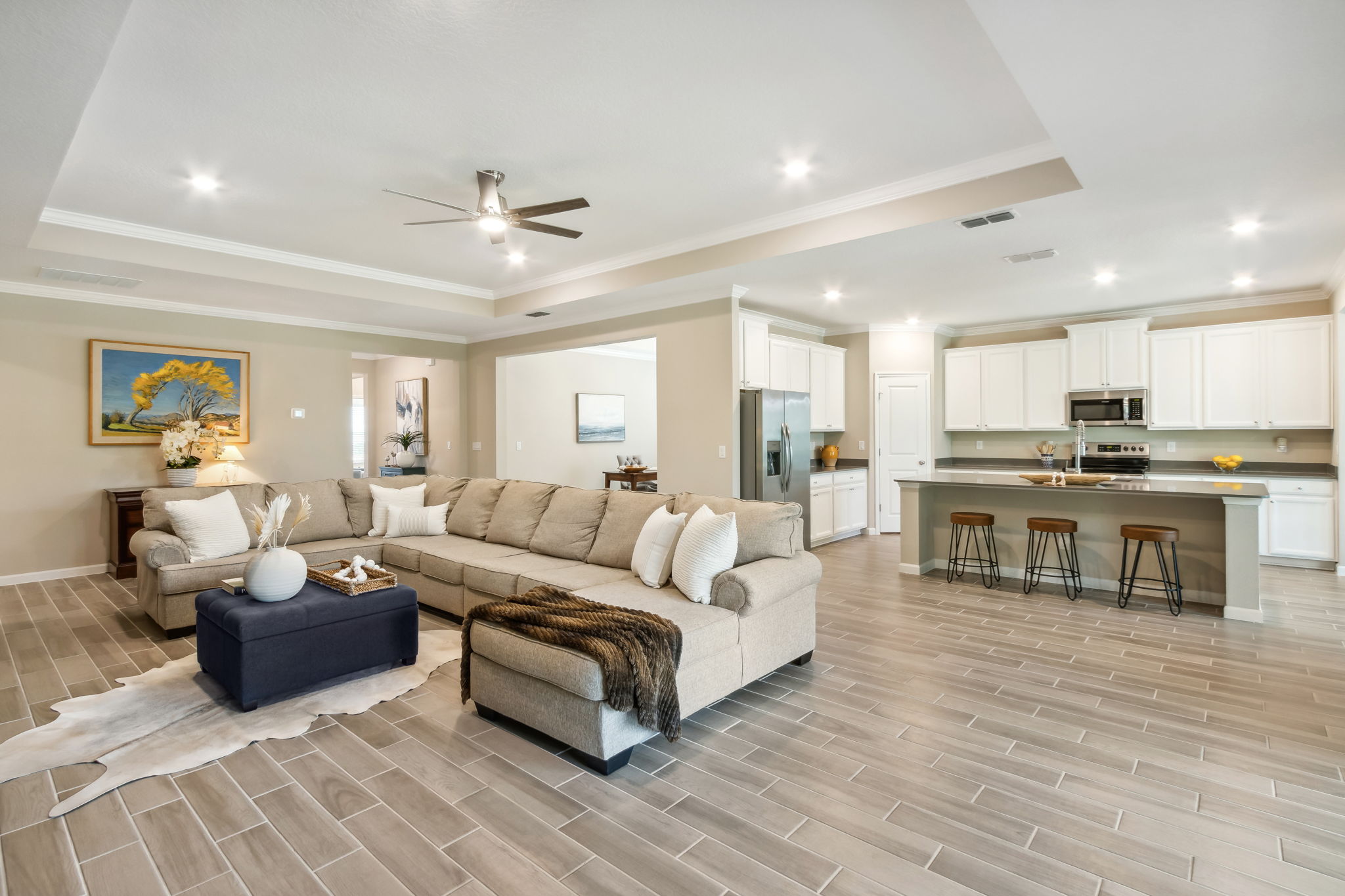 The oversized family room opens to the designer kitchen ...