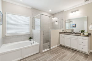 ...with dual vanities, relaxing soaking tub, and glass-enclosed shower