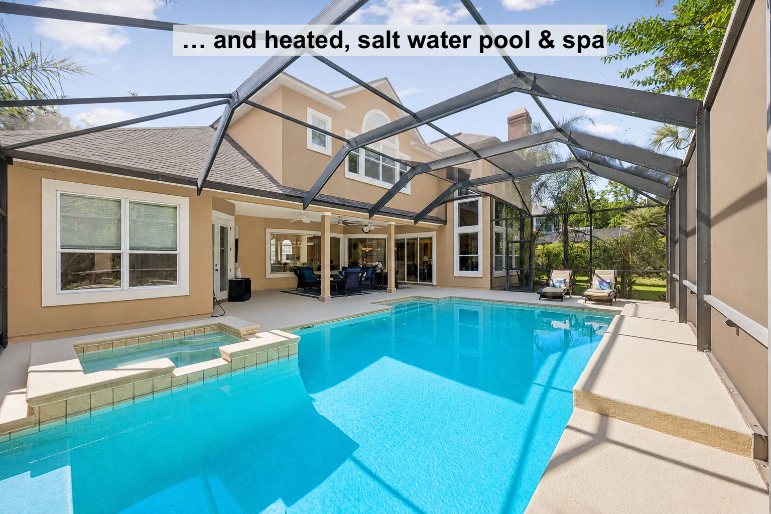 The outdoor living continues with a screened retreat featuring a heated saltwater pool and spa…