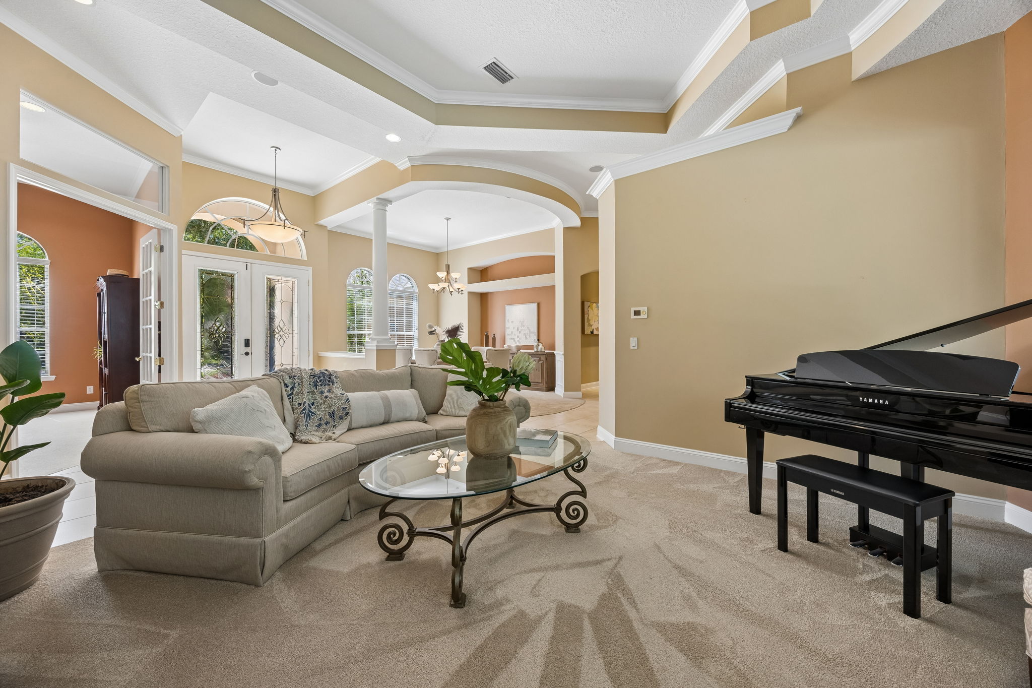 Just off the entry, the formal living room makes an elegant first impression with layered crown detail and a sculpted tray ceiling…