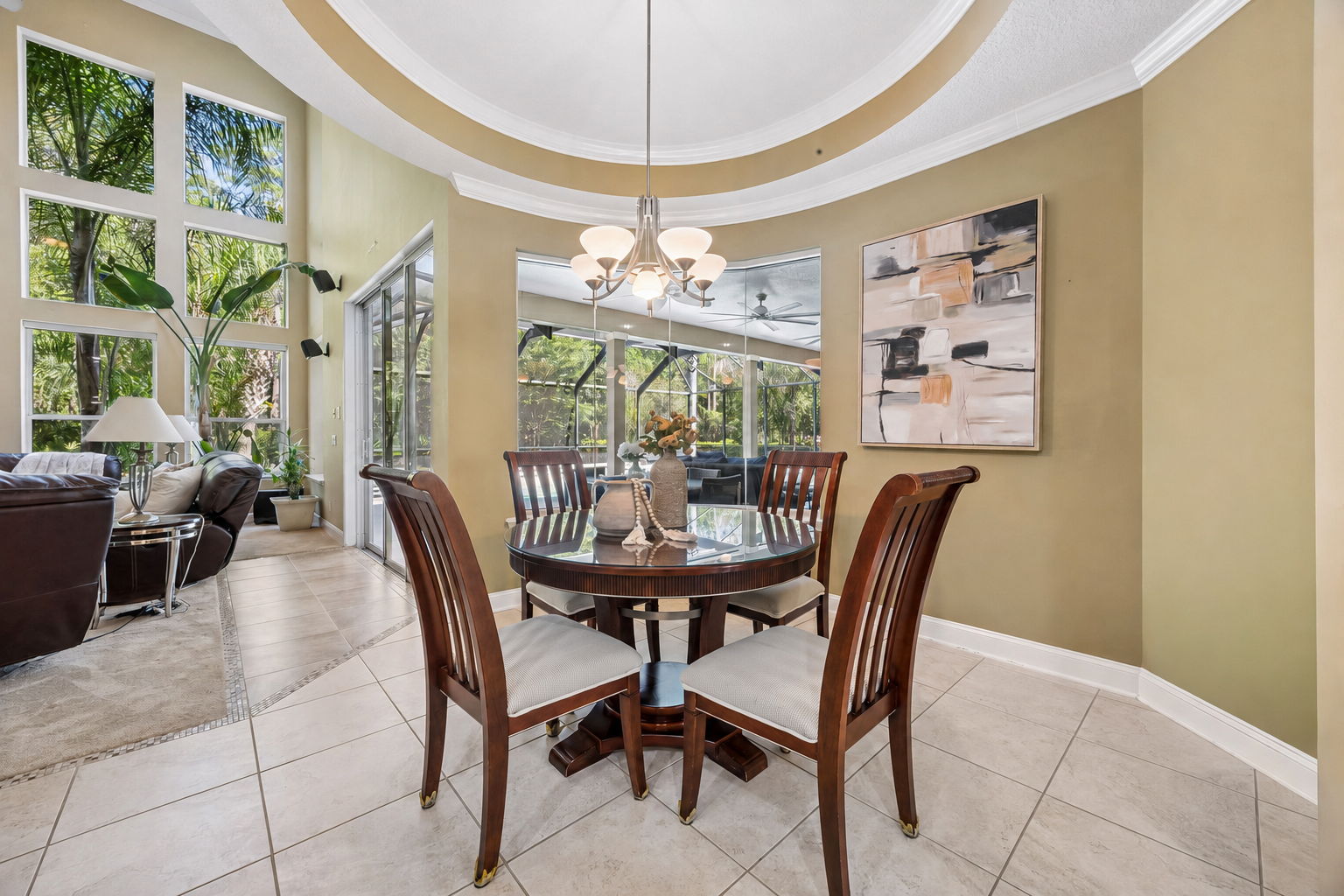 ... where the curved ceiling detail, tall windows, and poolside views make the space feel bright and inviting.