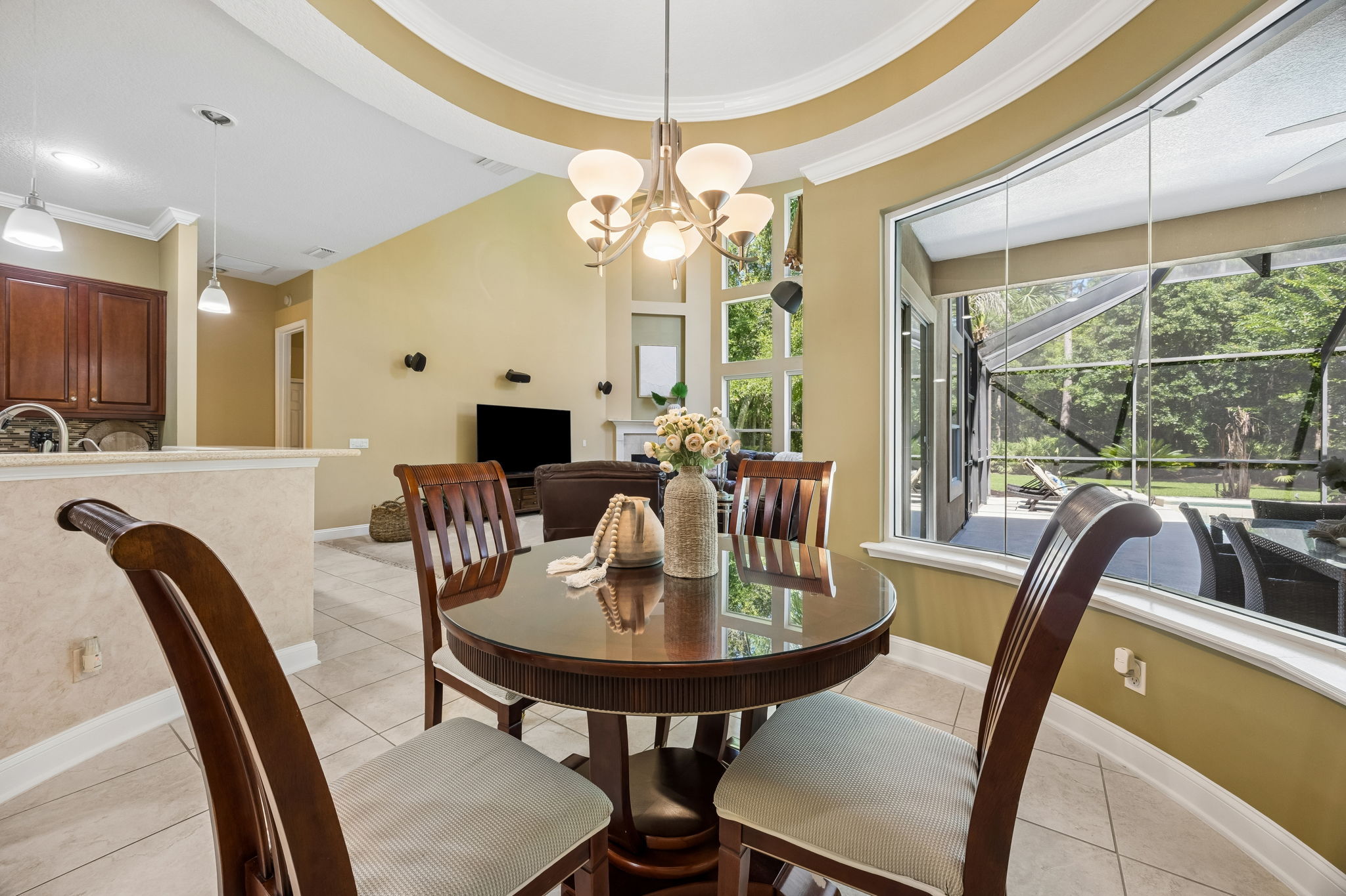 ... and a wide window framing the screened lanai, brings the outdoor setting beautifully into view.