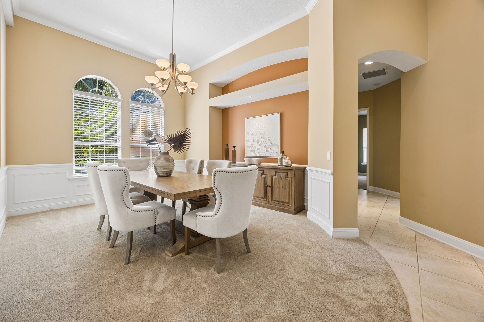 … where tall arched windows, paneled wainscoting, and a softly defined niche create an elegant setting for dinner and celebration.