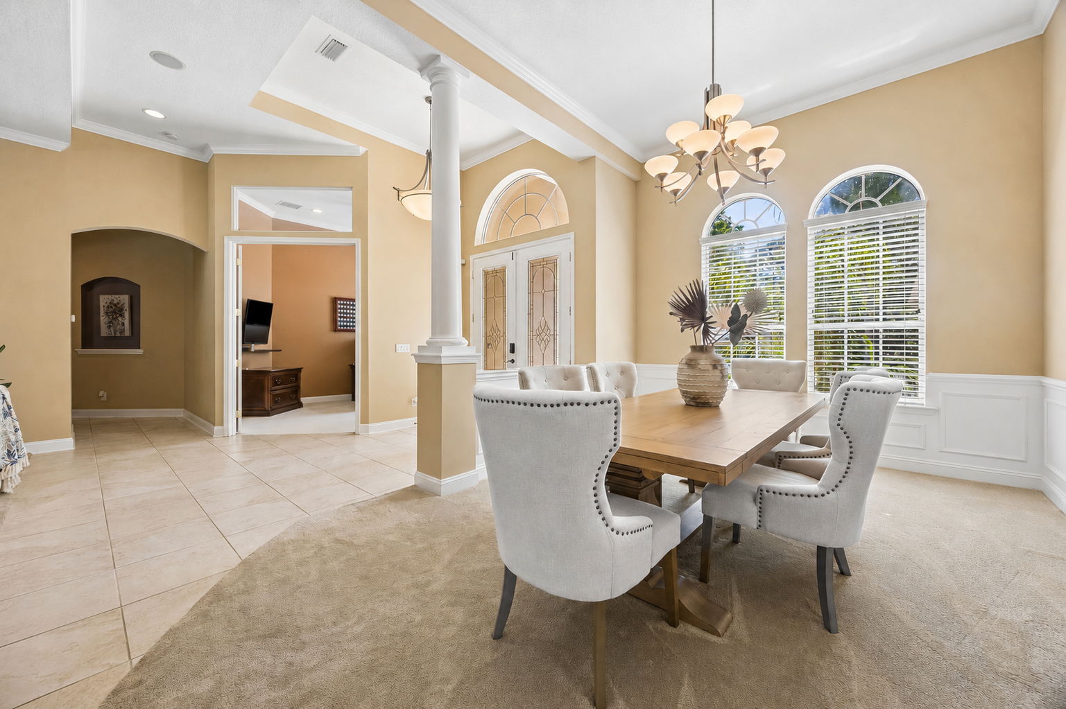 The dining room feels beautifully connected to the rest of the home, with architectural curves, generous scale, and a clear sense of arrival ...