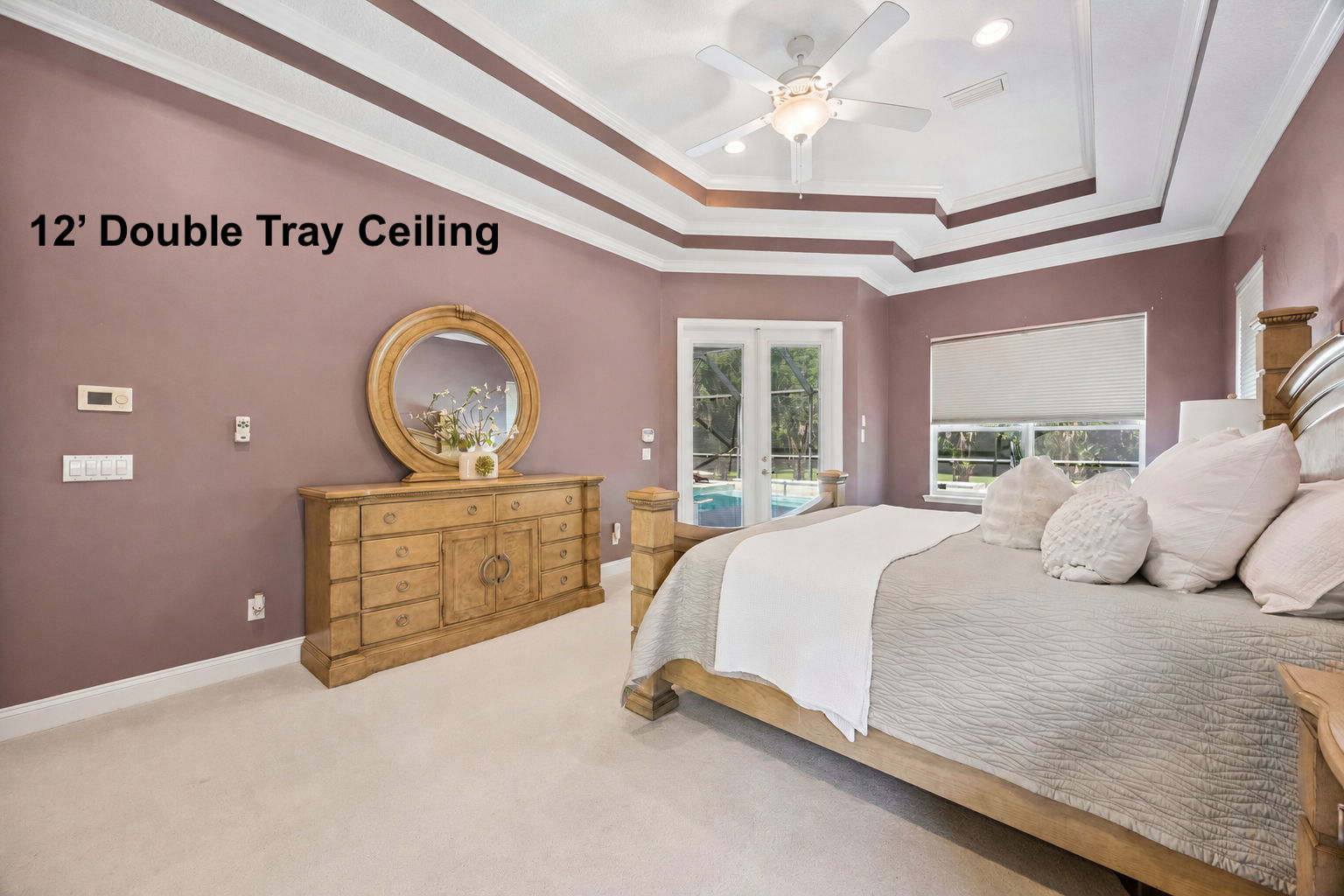 … while 12-foot ceilings, layered crown detail, and private doors to the lanai give the room a true sense of retreat.