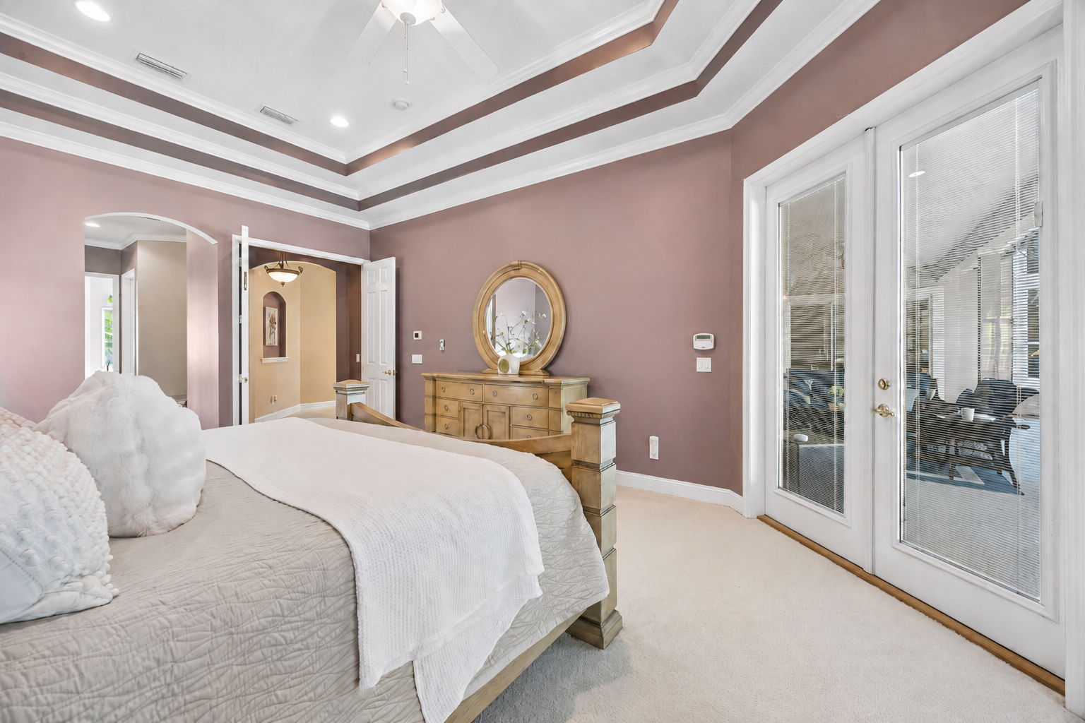 French doors open directly to the screened pool and outdoor living space ...