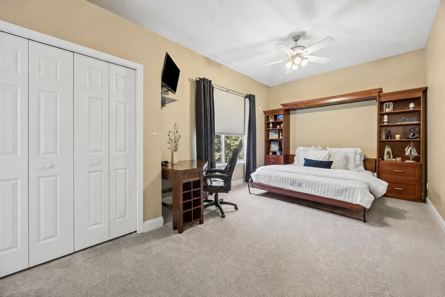 One guest bedroom is cleverly designed with a built-in king-size Murphy bed, desk space, and full closet storage ...