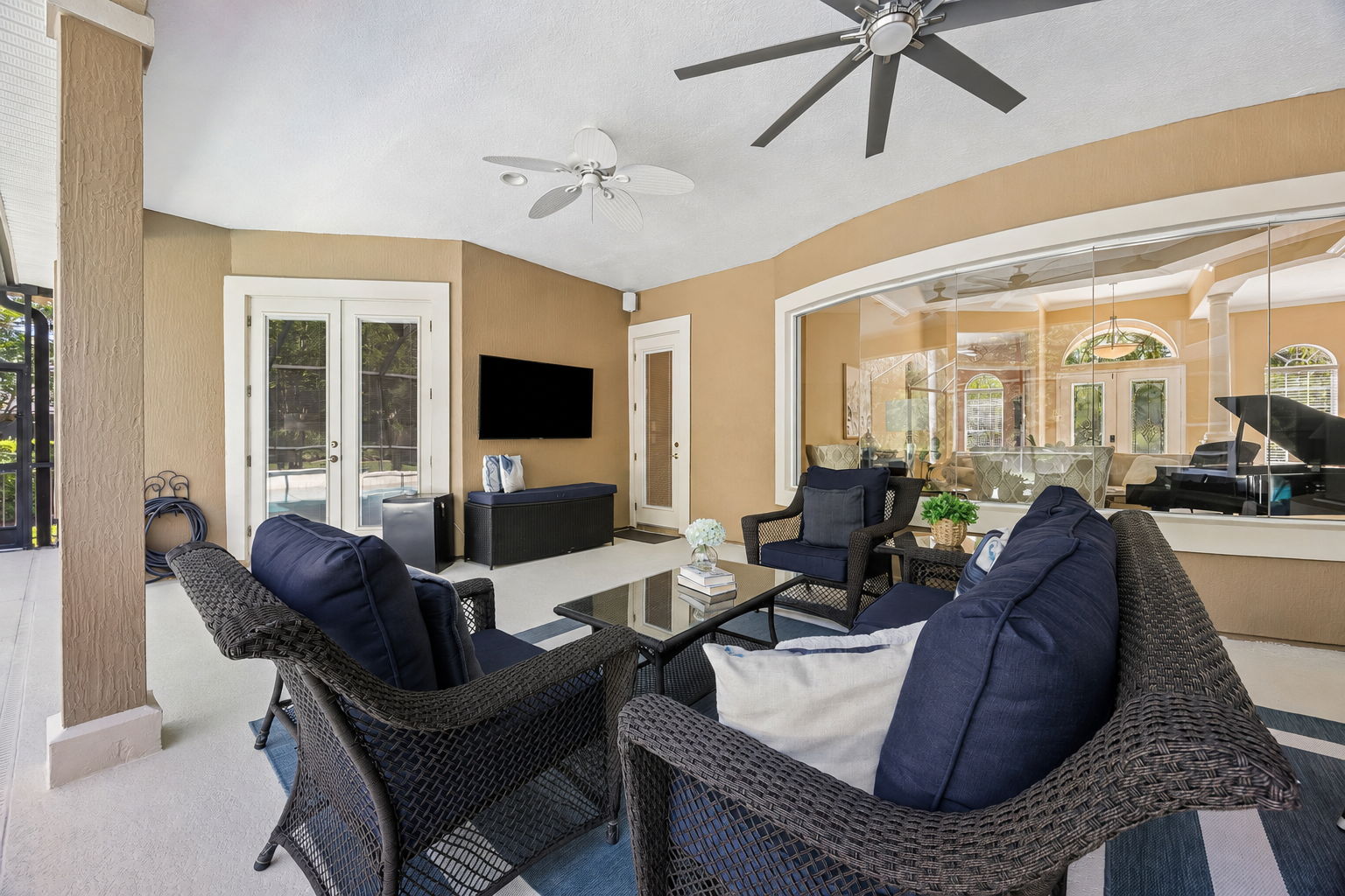 The covered lanai extends the living space outdoors, with comfortable seating, pool views, and room to relax in the shade ...