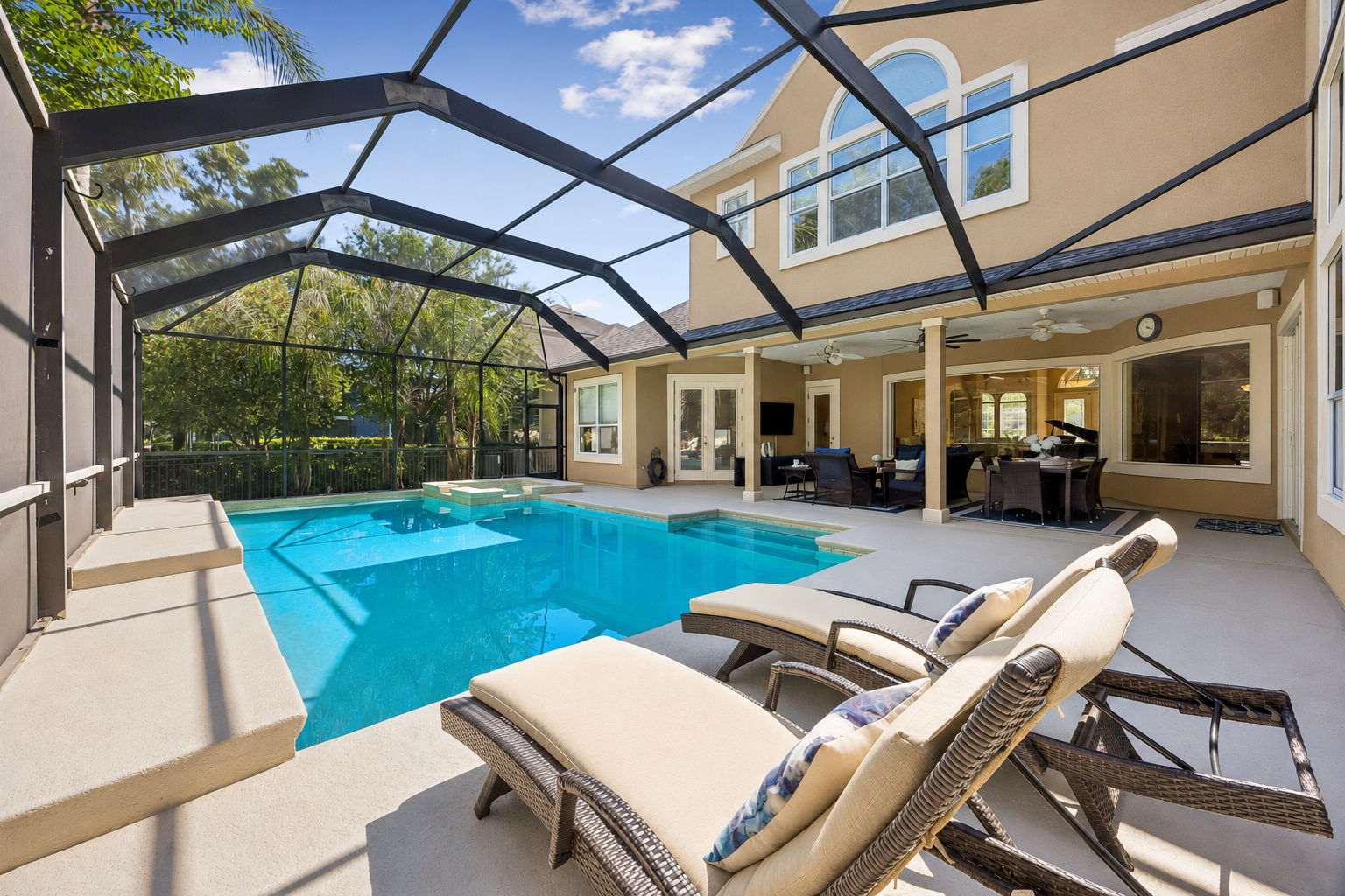 By day, there is room to swim, lounge, dine, and move easily between the lanai and the water ...