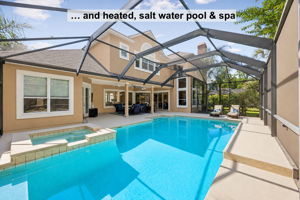 The outdoor living continues with a screened retreat featuring a heated saltwater pool and spa…