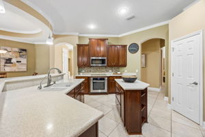 ... while warm wood cabinets, generous counter space, and a central island keep the kitchen highly functional.