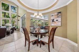 ... where the curved ceiling detail, tall windows, and poolside views make the space feel bright and inviting.