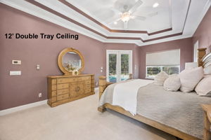 … while 12-foot ceilings, layered crown detail, and private doors to the lanai give the room a true sense of retreat.