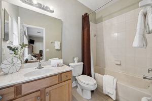 The ensuite bath adds comfort and independence to the second-floor bedroom with a tub-shower combination, vanity, and bright, clean finishes.