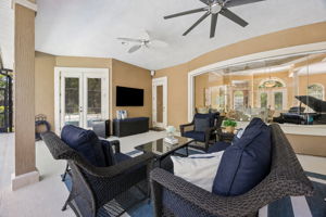 The covered lanai extends the living space outdoors, with comfortable seating, pool views, and room to relax in the shade ...