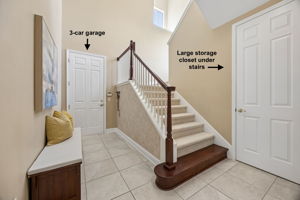 A practical transition hall leads to the 3-car garage, with a large under-stair storage closet tucked nearby ...