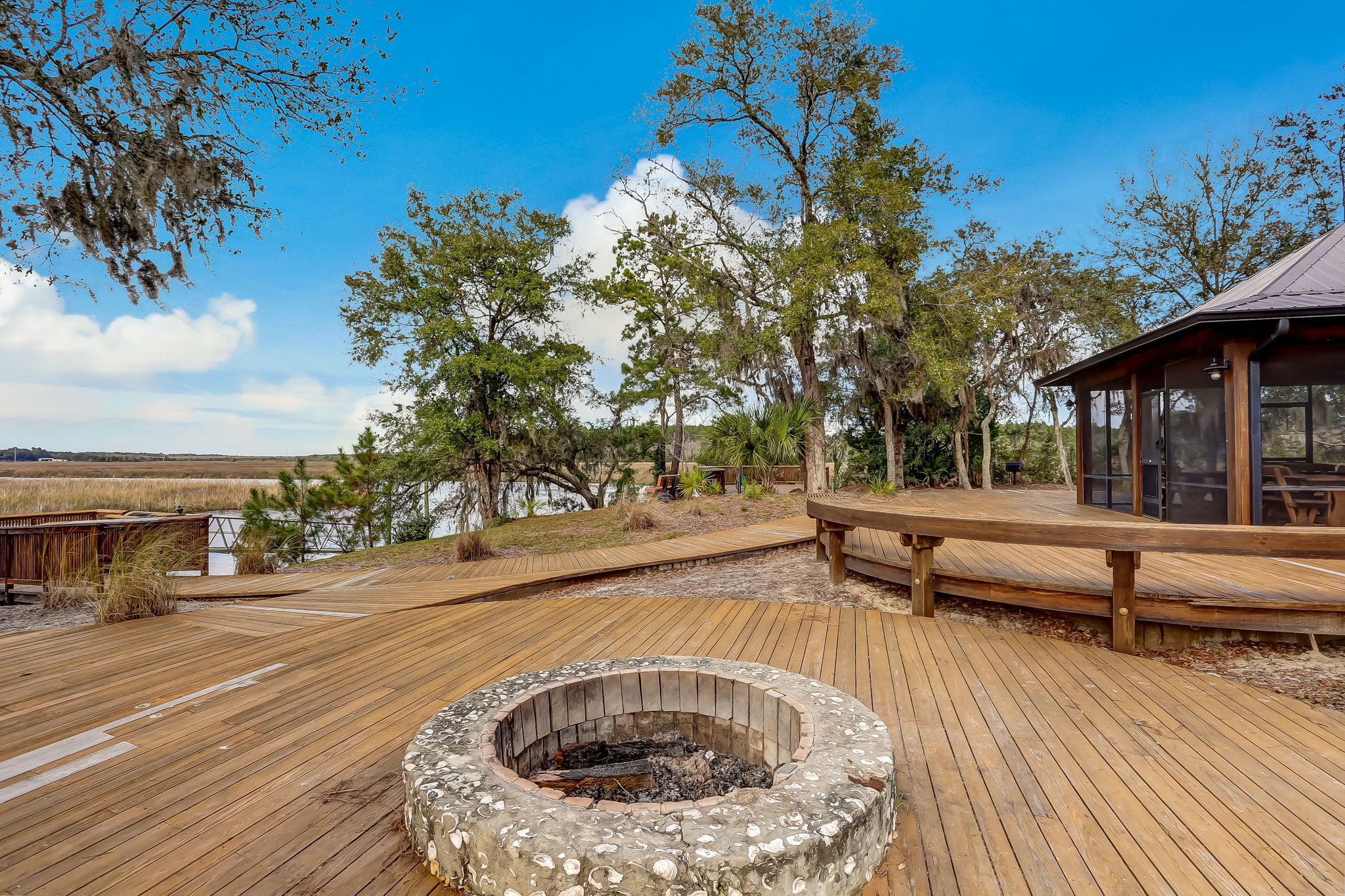 If features extensive decking, firepit, oyster roasting pit ...