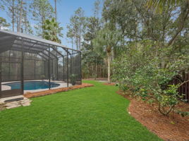 Beyond the pool, the backyard continues with ample green space