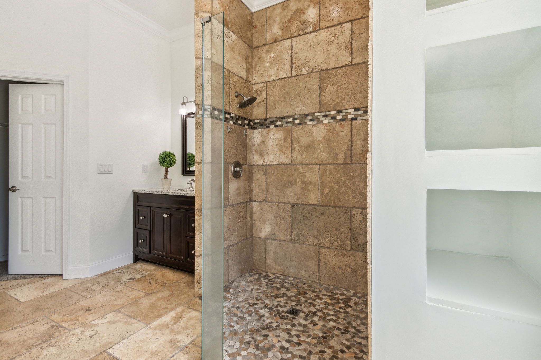 ...plus a modern shower with seamless door and handsome blend of tiles ...