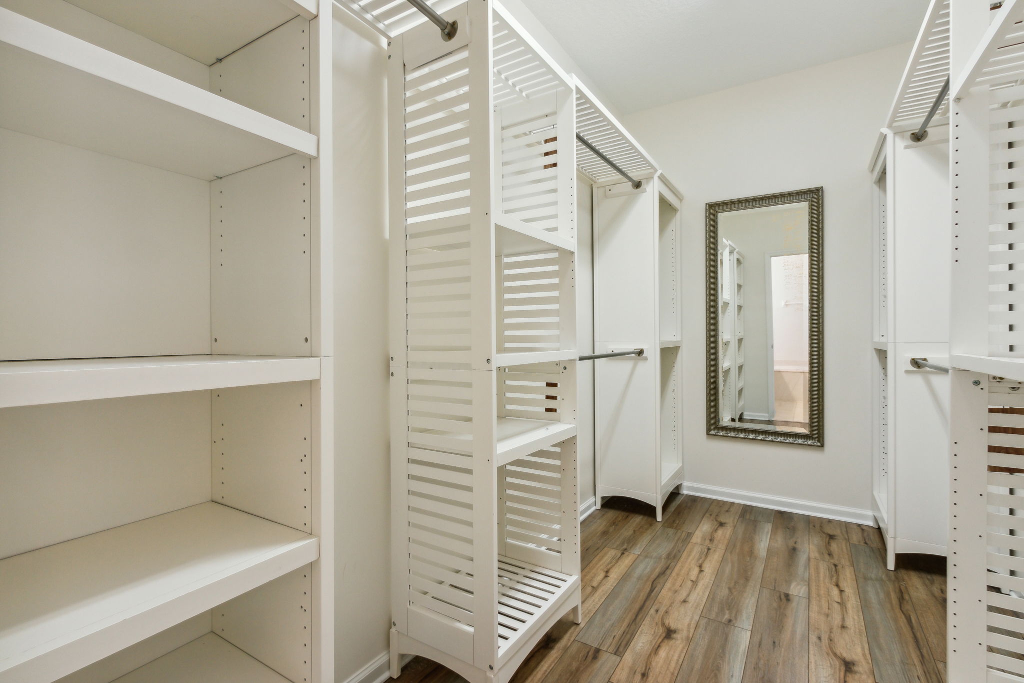 Primay walk-in closet with upgraded shelving