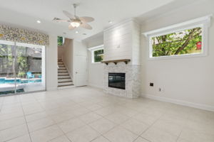 Gathering room featuring abundant natural light and new tile and shiplap fireplace surround.