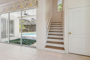 Stairs to separate living area with storage under the stairs.