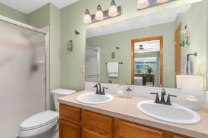 Primary bathroom with new sinks, faucets, and toilet