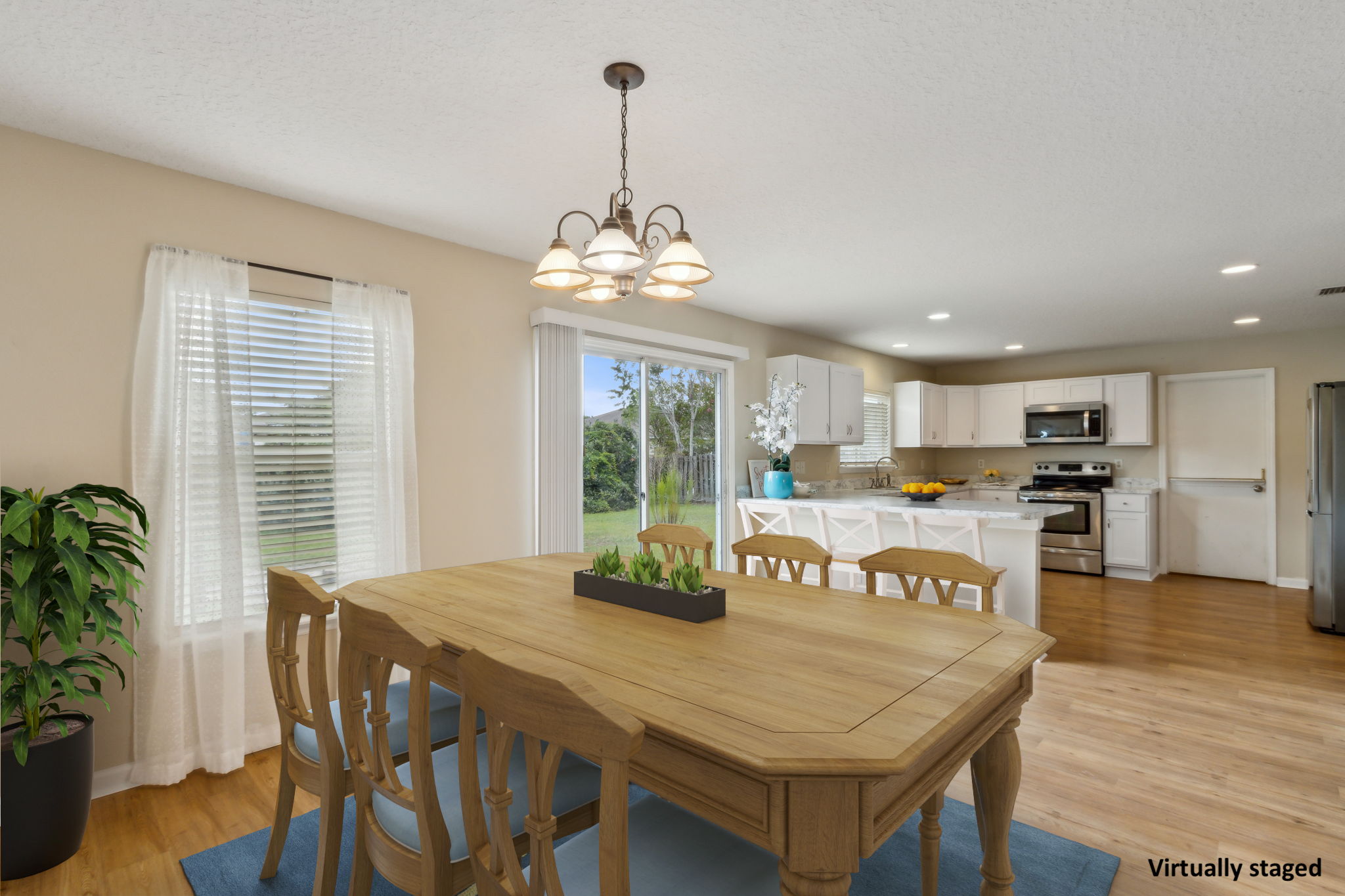 The kitchen opens to a dining area that easily accommodates a large group ...
