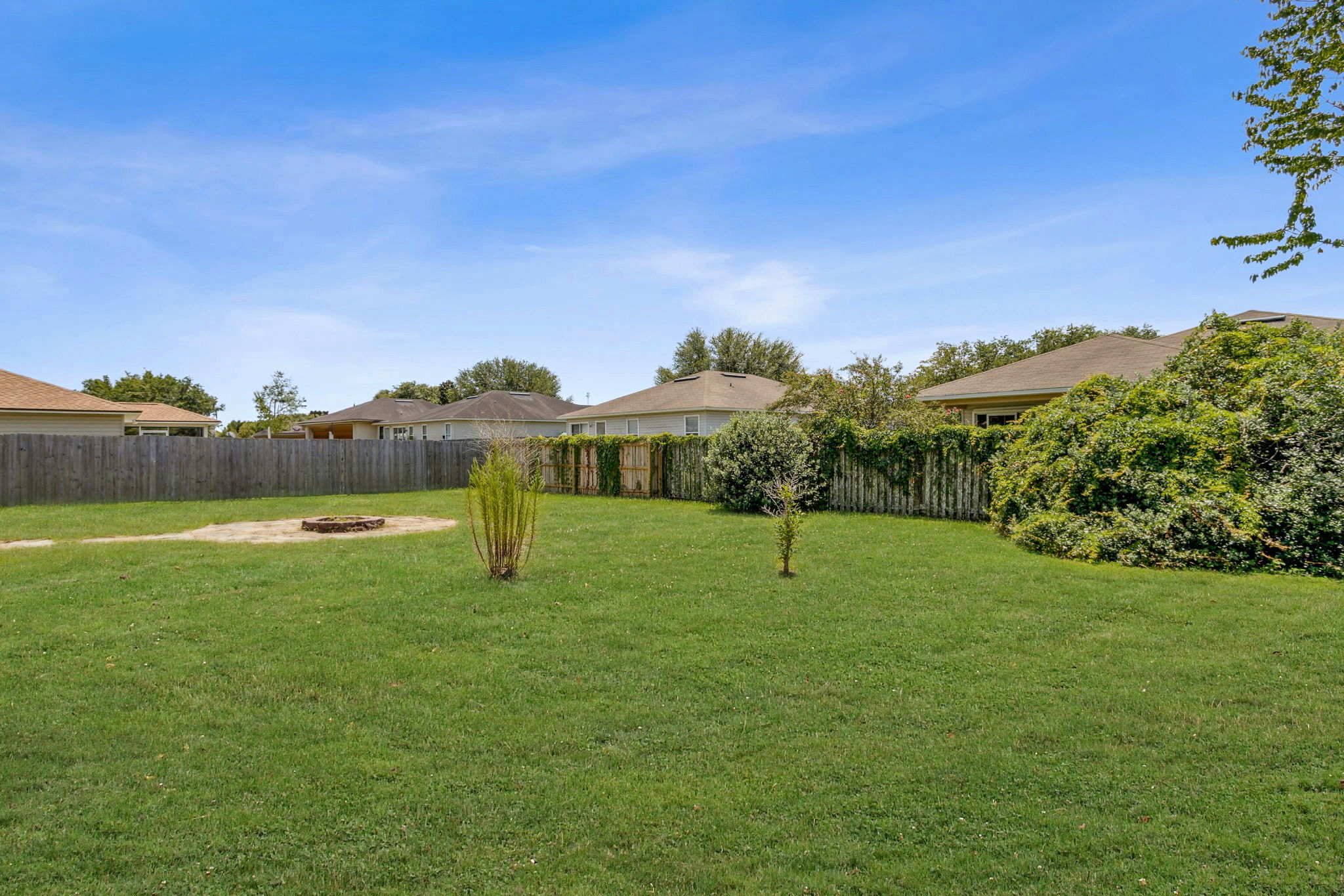 ...the fully fenced back yard is spacious ...