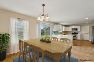 The kitchen opens to a dining area that easily accommodates a large group ...