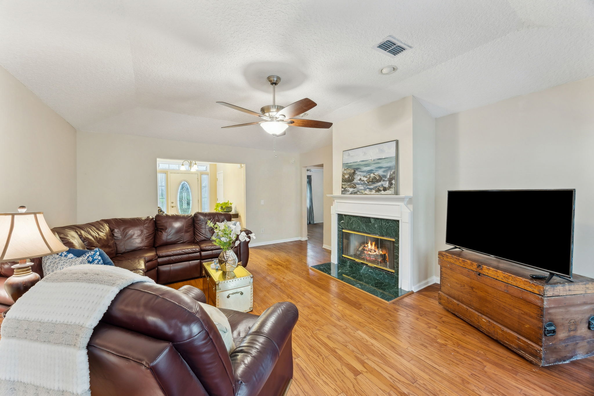 ... with honey-colored hardwood floors throughout the entry and family room