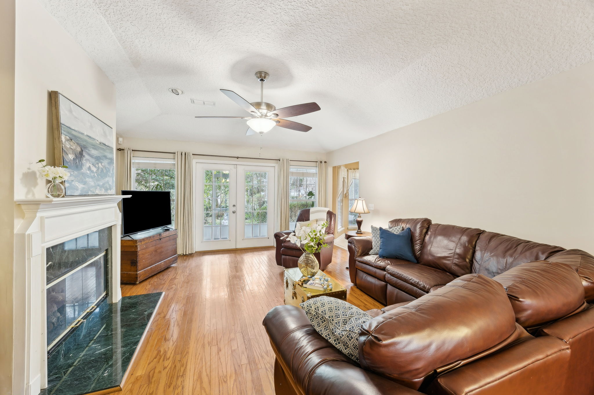 ... with French-door access to the screened porch, overlooking the tree-filled backyard.