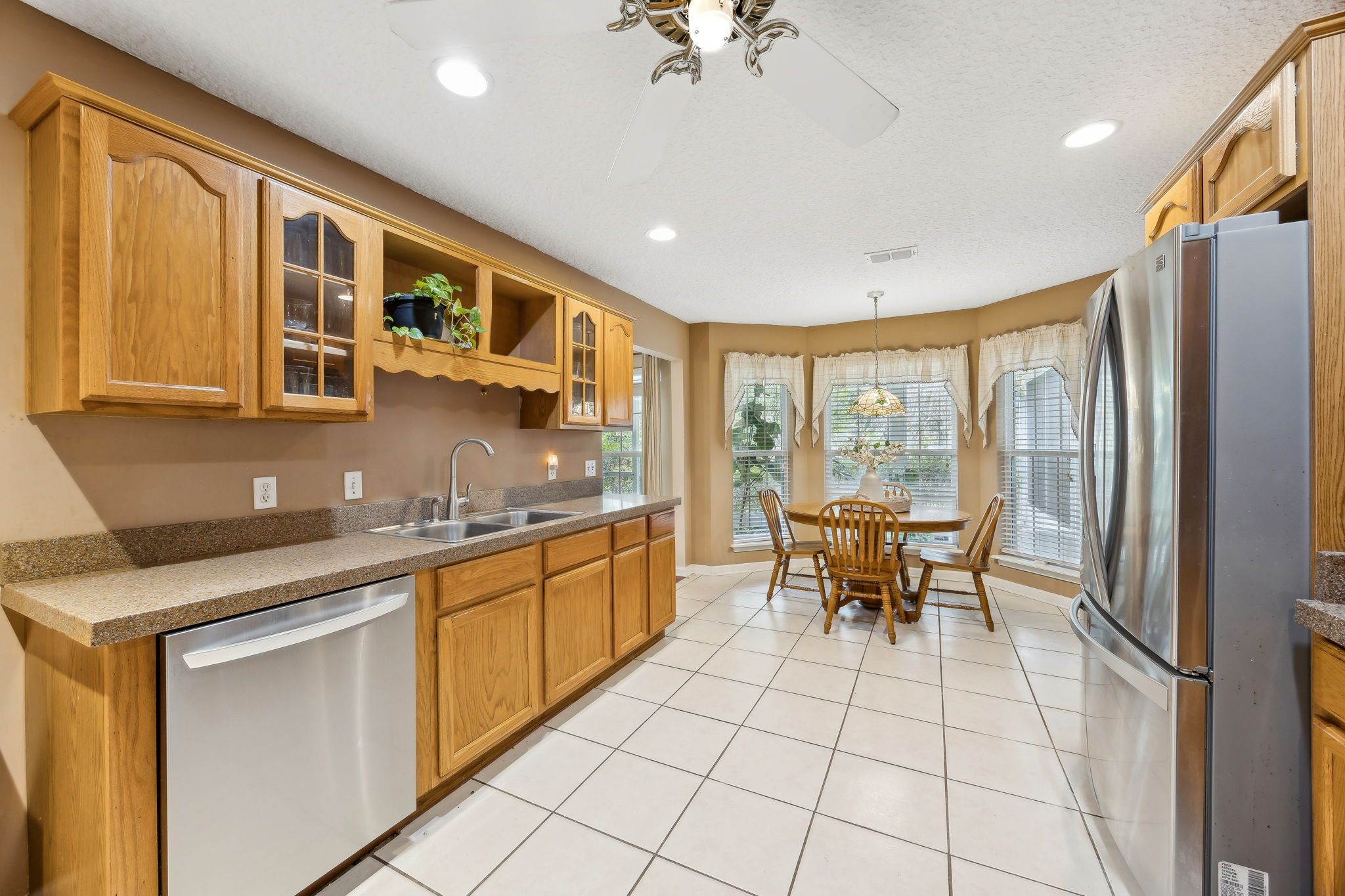 The kitchen features stainless steel appliances, ample cabinetry ...
