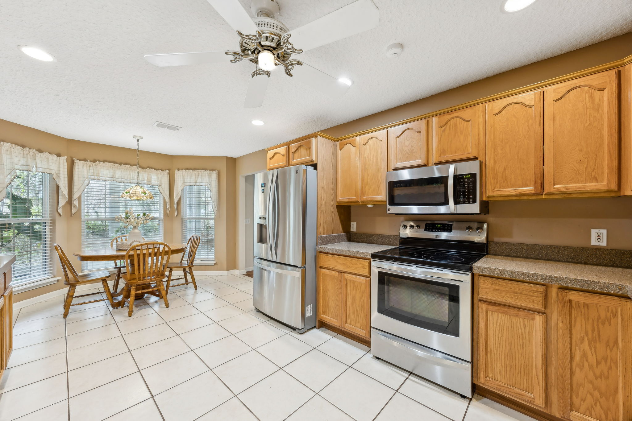 ... counters with granite overlay, and tile flooring.
