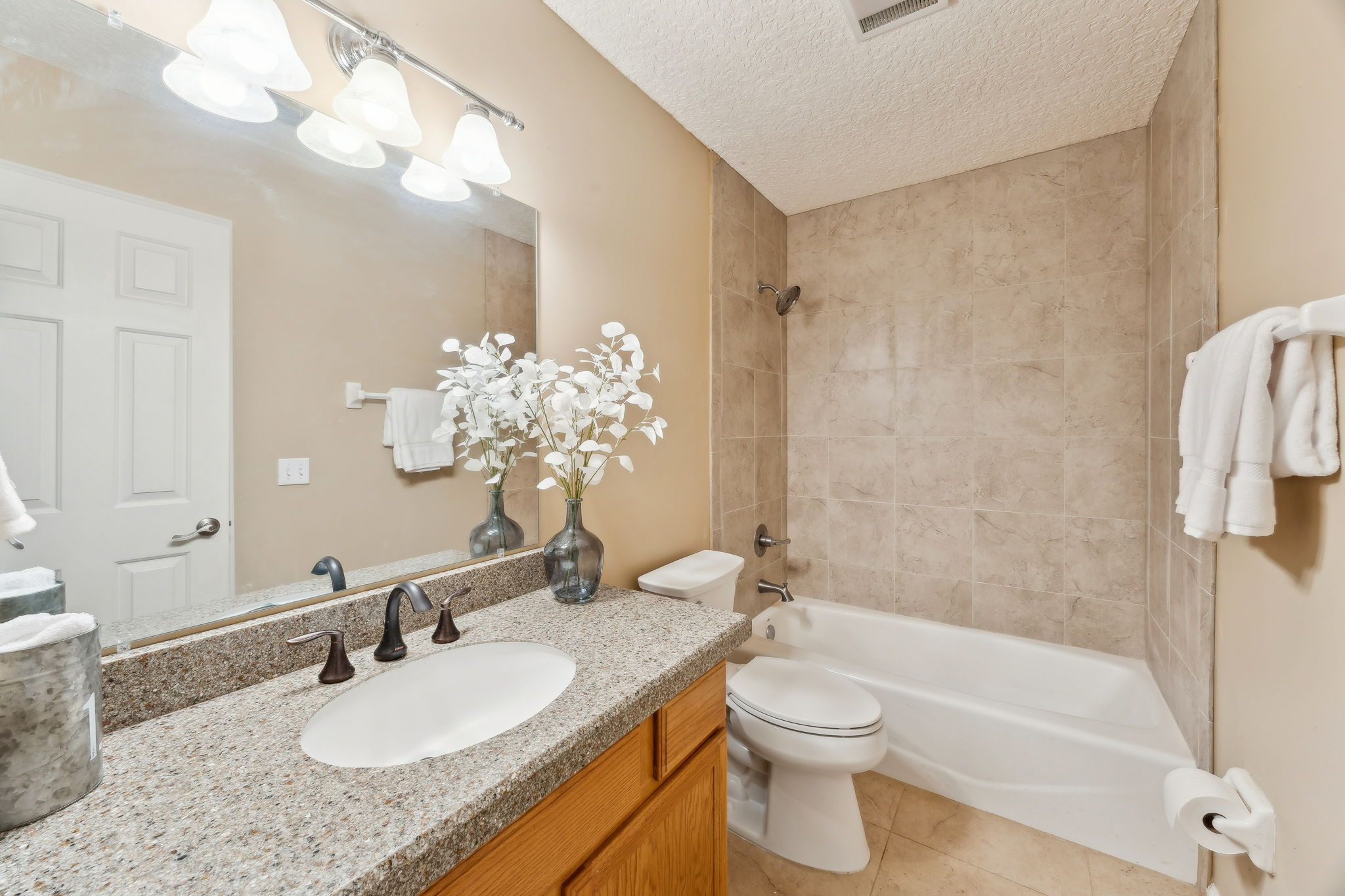 The guest bath is between the two bedrooms with granite counters and a tiled tub/shower.