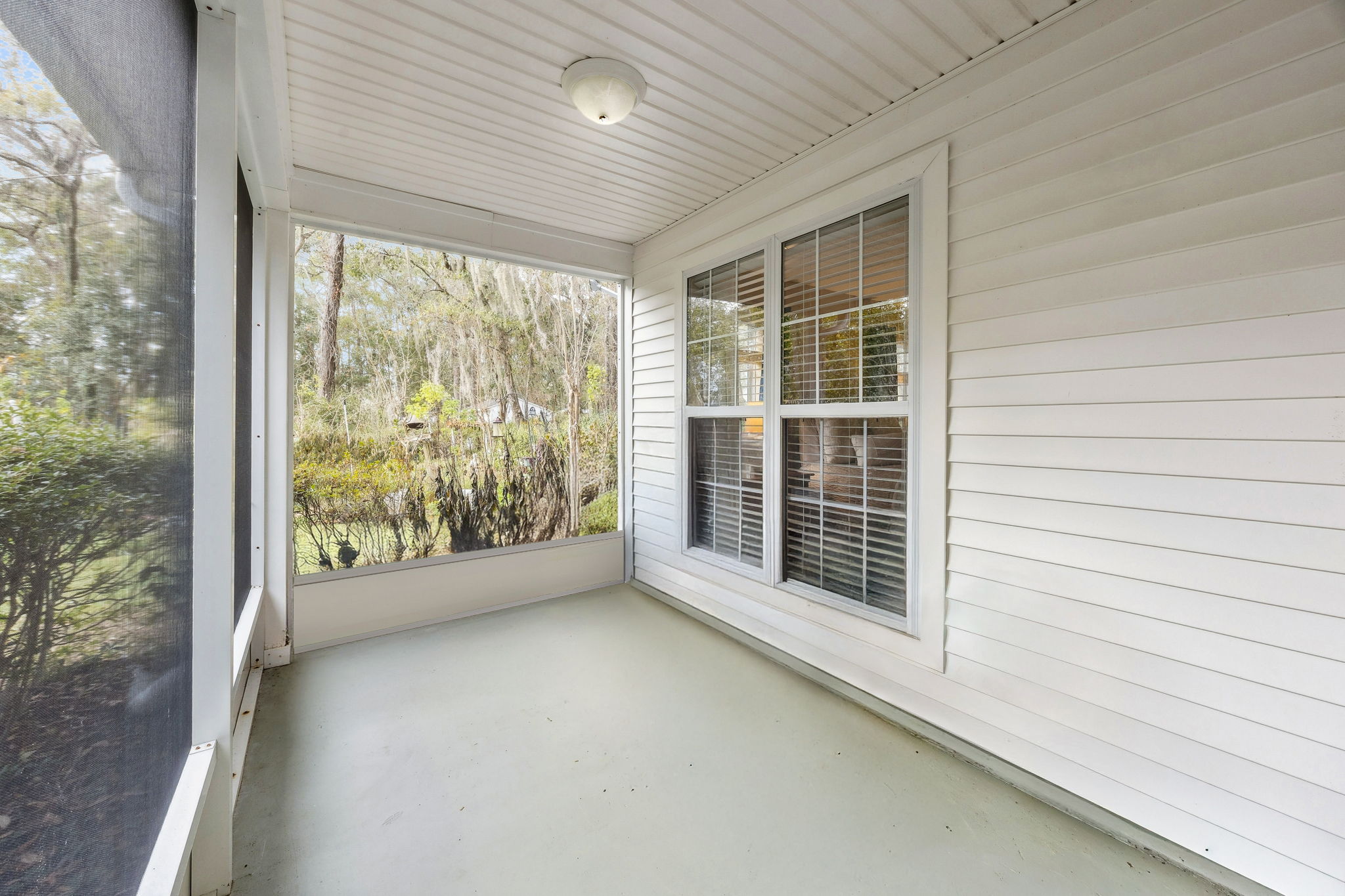 The screened porch spans the length of the home ...