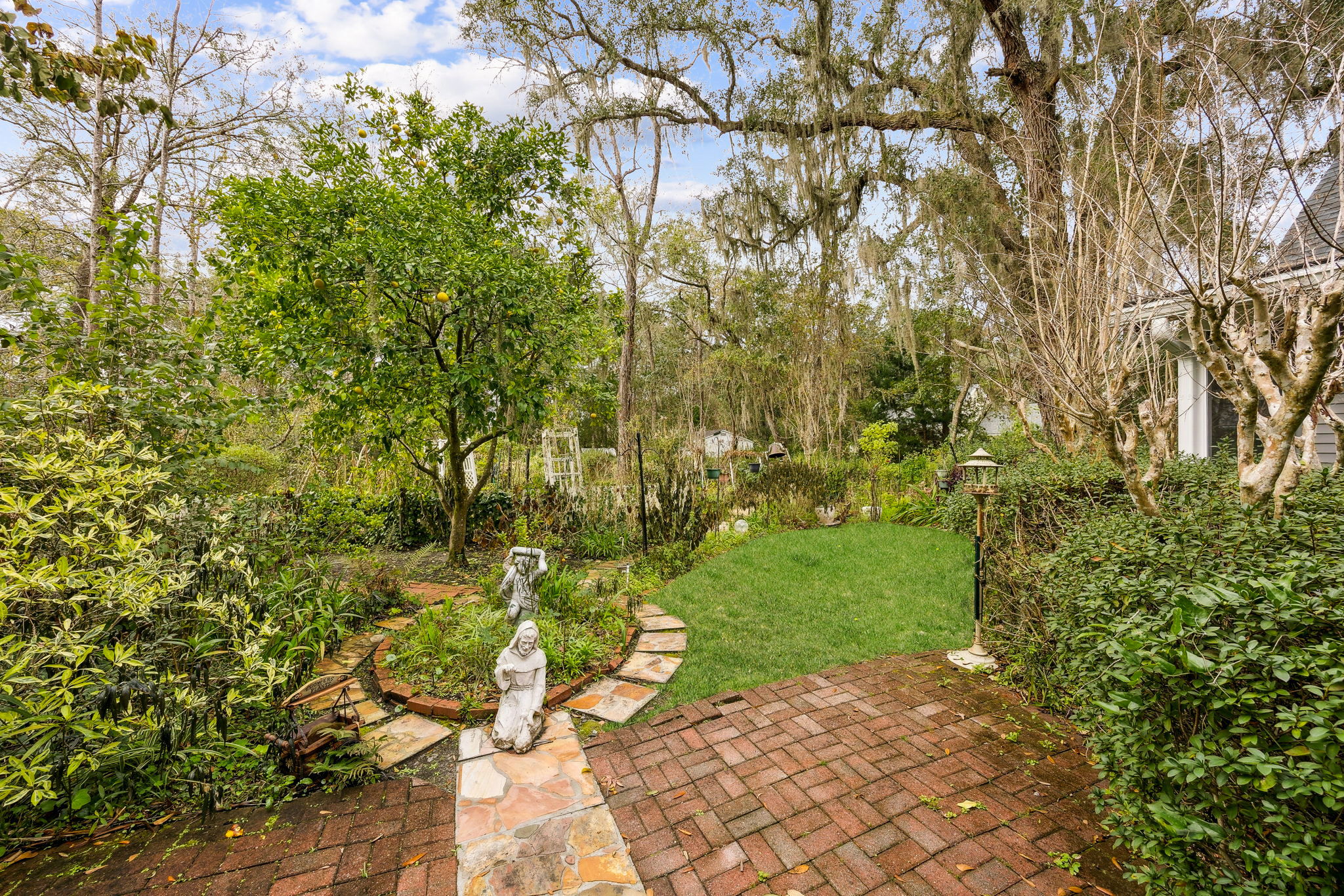 The backyard unfolds like a classic English garden ...