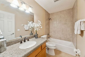 The guest bath is between the two bedrooms with granite counters and a tiled tub/shower.