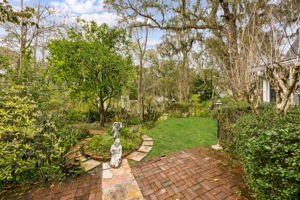 The backyard unfolds like a classic English garden ...