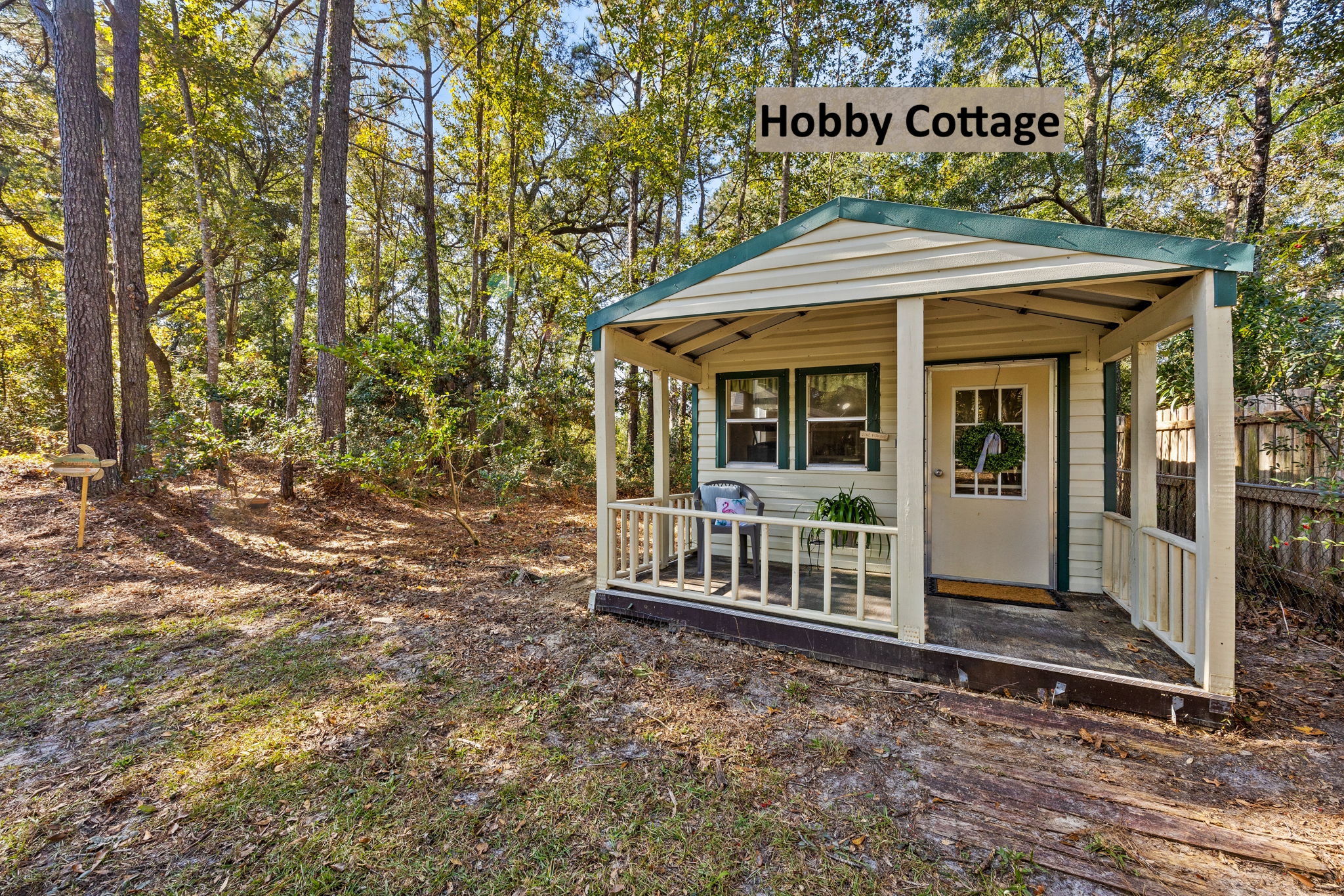 The grounds feature three outbuildings, including this cute hobby cottage.