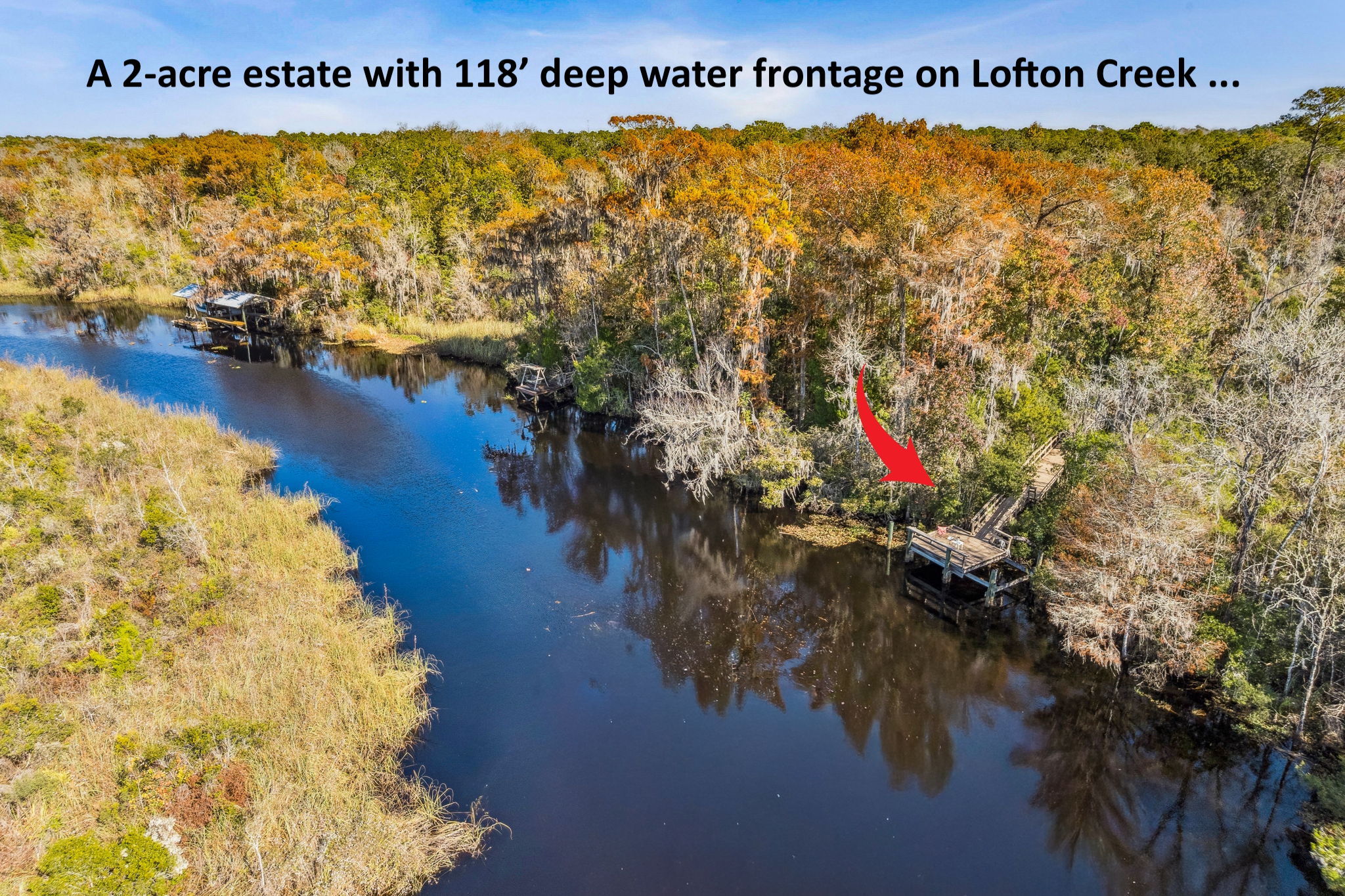 Located on a two acre estate directly on Lofton  Creek...