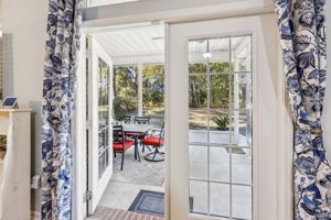French doors reveal a generous screened porch ...