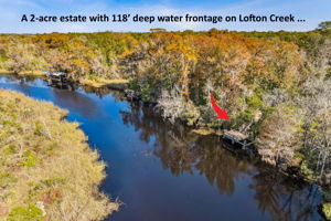 Located on a two acre estate directly on Lofton  Creek...