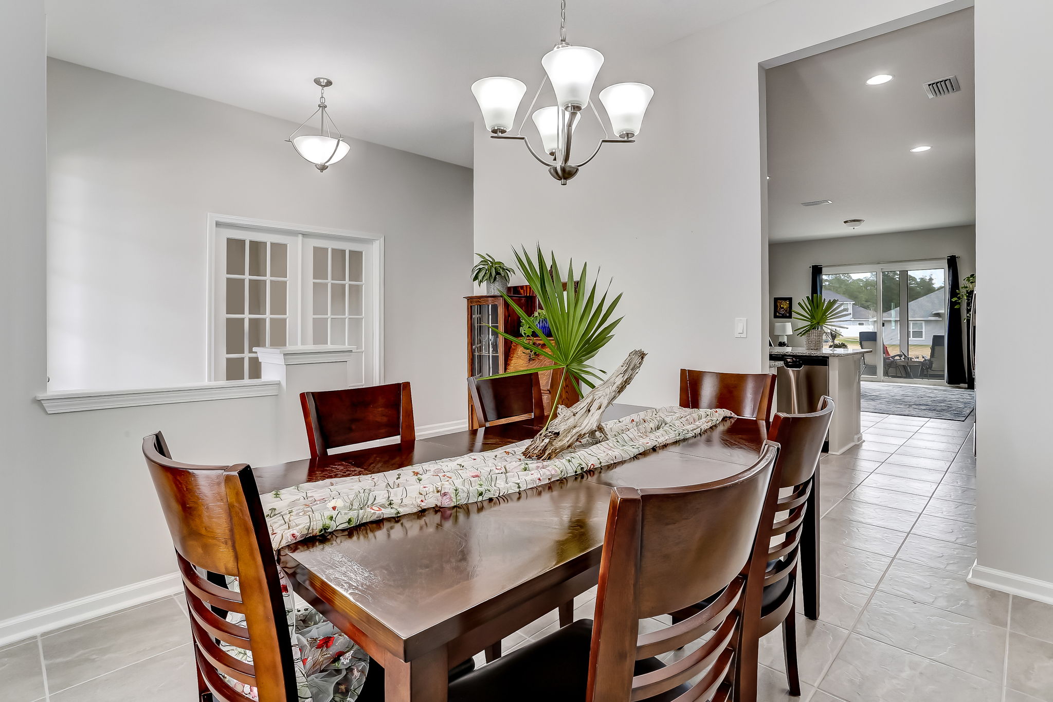 A perspective showing line-of-sight from dining to kitchen to living area  ...