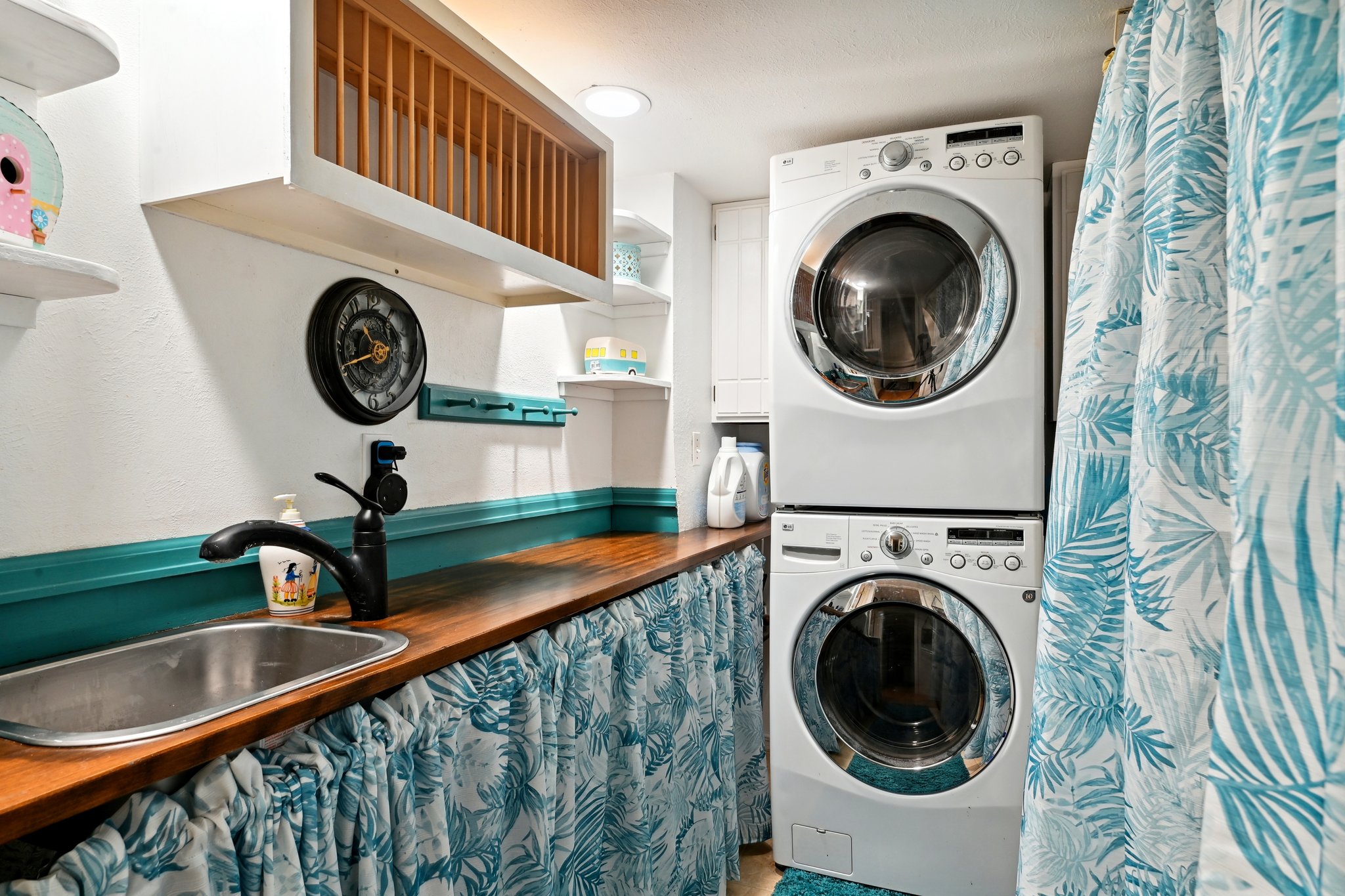 Laundry room with sink is located in the lower level.