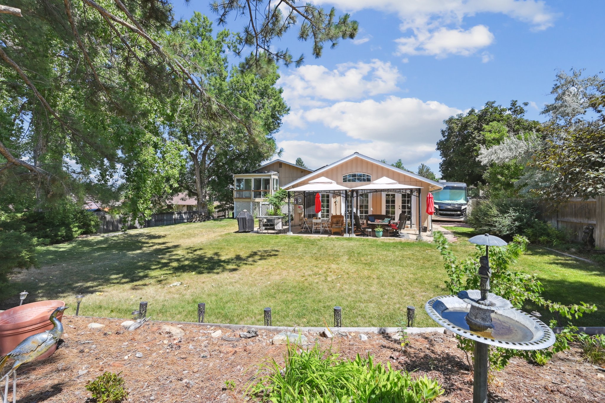 Great big back yard with mature trees and plenty of sunshine.