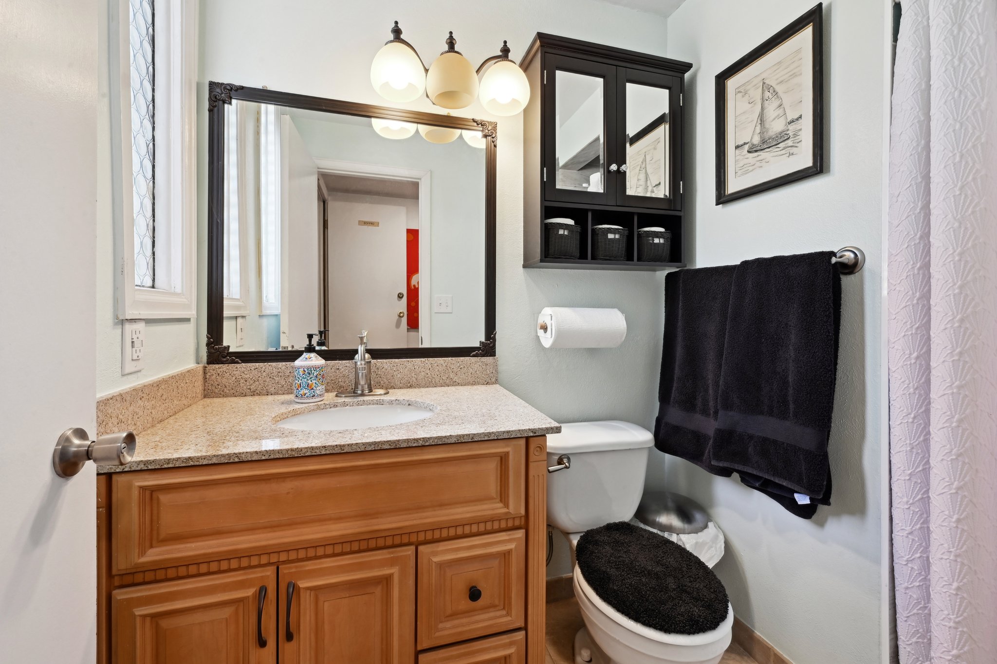 Lower level bathroom right off garage is perfect for cleaning up after working in the yard/garage!