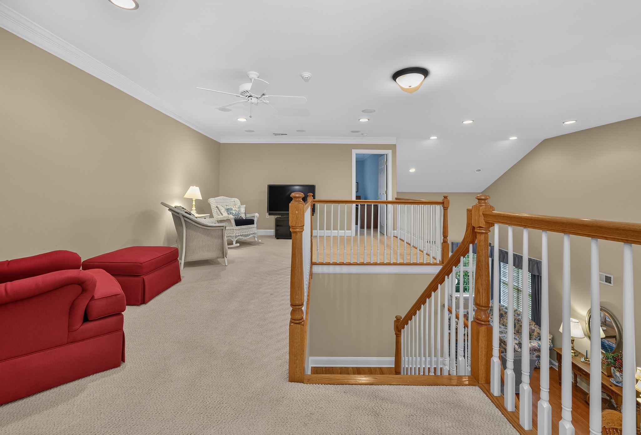 LOFT This versatile space features recessed lighting, crown moulding, a ceiling fan, and carpeting, making it ideal as a family room, home office, or hobby area.