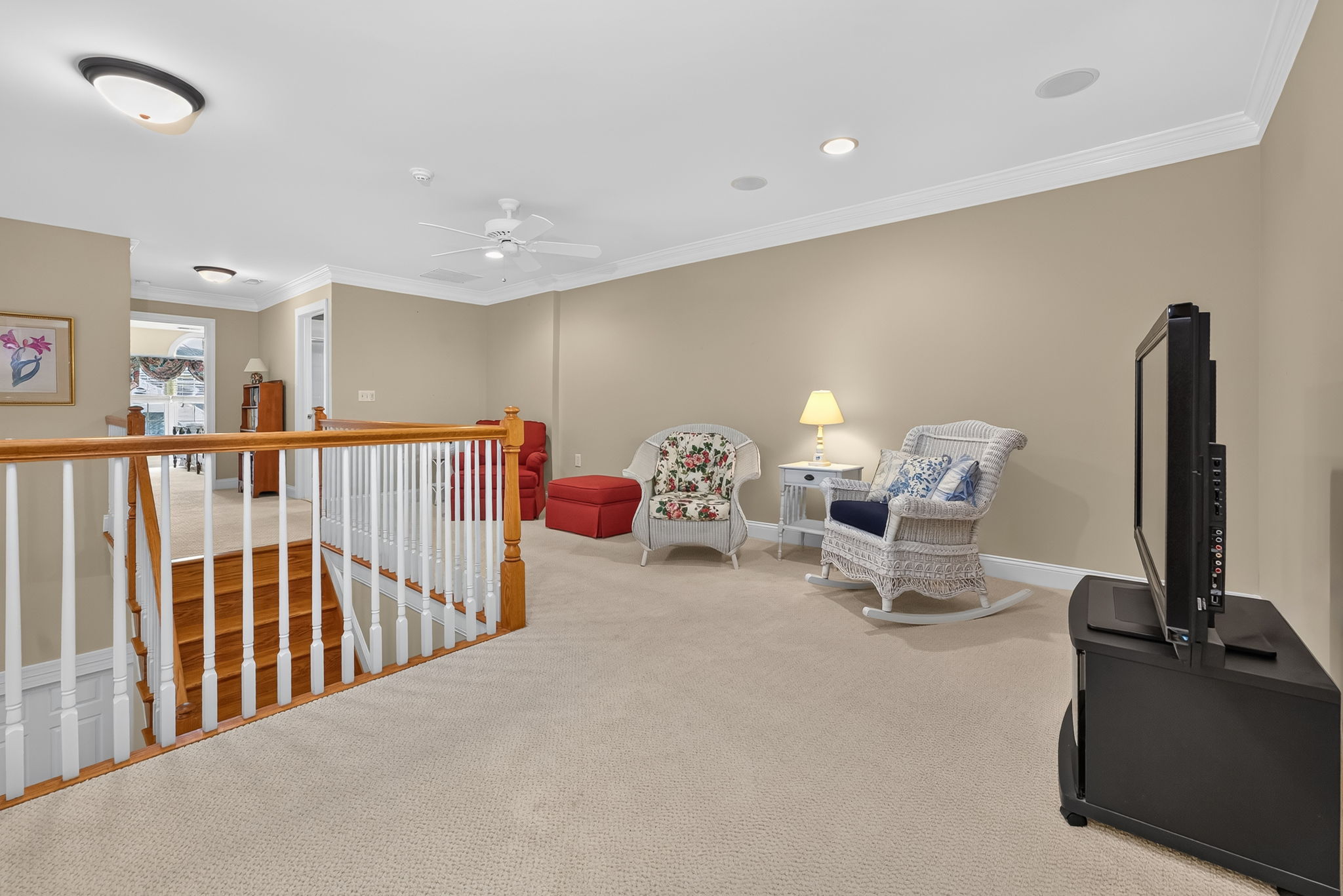 LOFT This versatile space features recessed lighting, crown moulding, a ceiling fan, and carpeting, making it ideal as a family room, home office, or hobby area. ATTIC STORAGE ROOM Generous attic storage